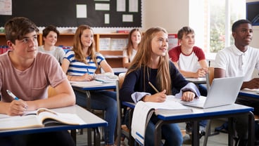 students in a classroom facing forward at their desks