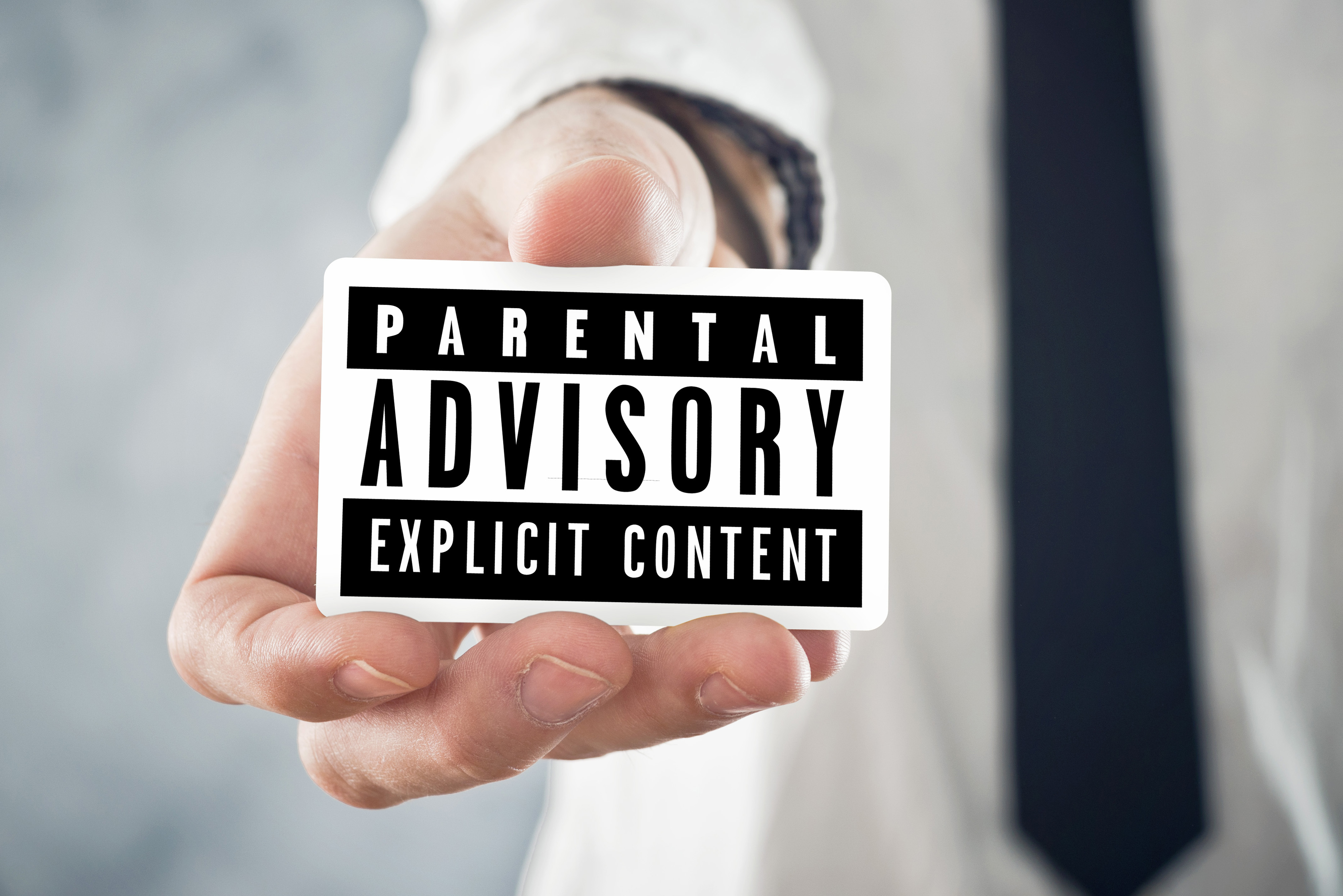 Person holding parental advisory sticker