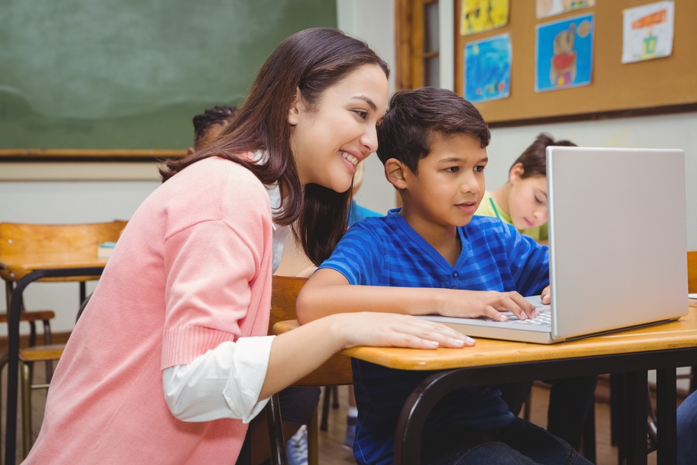 teacher and student on school laptop