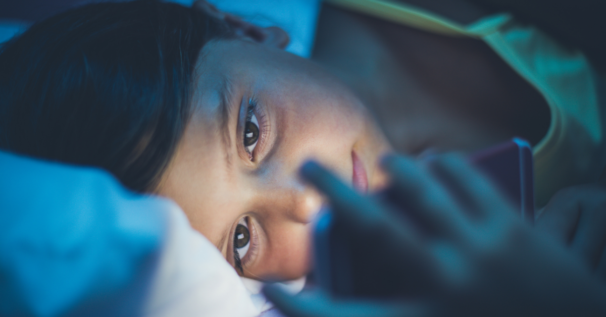 child on phone at night