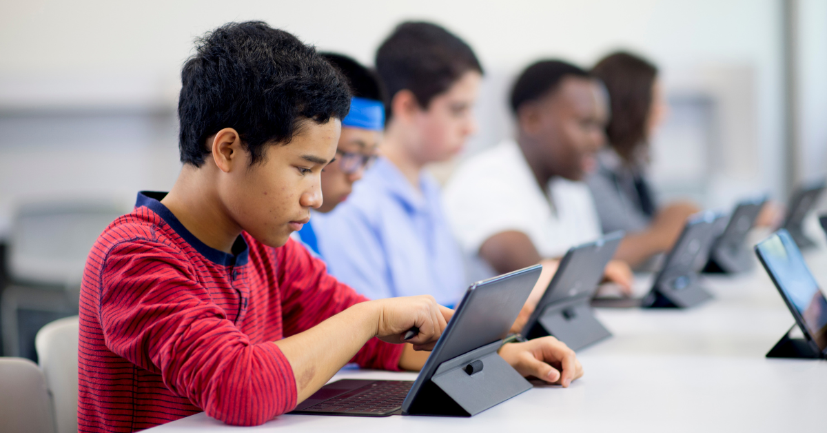 children using tablets at school